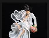 The Seakoff Goku and Chi-Chi Wedding Collectible Figure captures Goku in a white suit and Chi-Chi in a bridal gown, with Goku holding pink roses, set against a black background. This 31cm Dragon Ball Z collectible is perfect for fans.