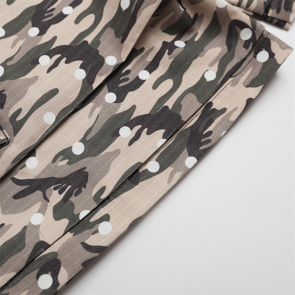Side close-up of camo cargo shorts leg with seam detail and polka dot camouflage print