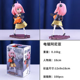 The Anya Forger Chainsaw Cosplay Figure from Spy × Family is a charming 18CM PVC action figure featuring pink hair and an orange giraffe on a purple base. The packaging displays foreign language text detailing this anime collectible&