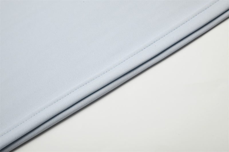 Close-up of light blue shirt hem with stitched edge