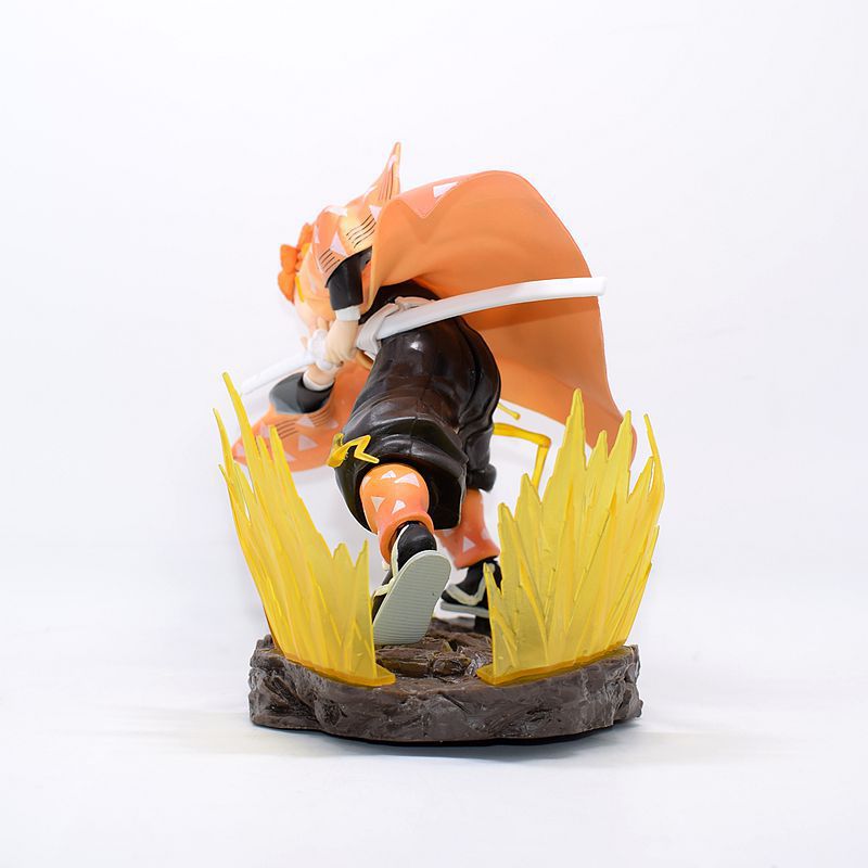 The Demon Slayer Zenitsu Agatsuma Figure, a 14.5cm high-quality PVC collectible weighing 300g, features a dynamic pose from behind in an orange cloak. Yellow flame-like elements evoke Thunder Breathing techniques on a rocky base, adding action and movement.