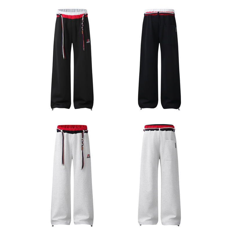 Pantalon de survêtement à jambes larges avec double ceinture et cordon tressé