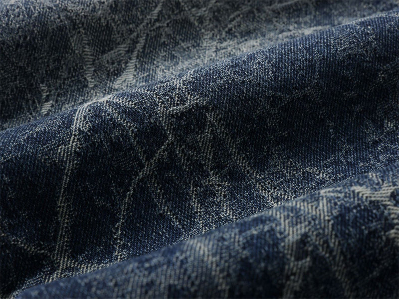 Close-up of denim fabric texture with vintage wash and light distressing