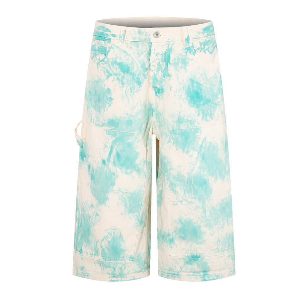 Tie-dye wide-leg denim shorts in cream and aqua blue with cargo-style pockets, front and back view