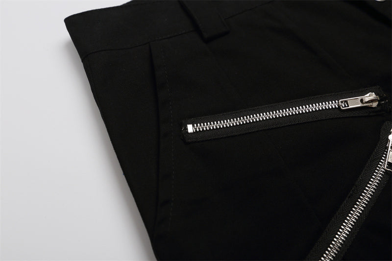 Close-up of black shorts side panel showing a horizontal zipper pocket