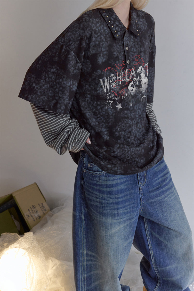 Angled view of a dark mottled faux-layered polo shirt with striped sleeves and red-and-white chest graphic