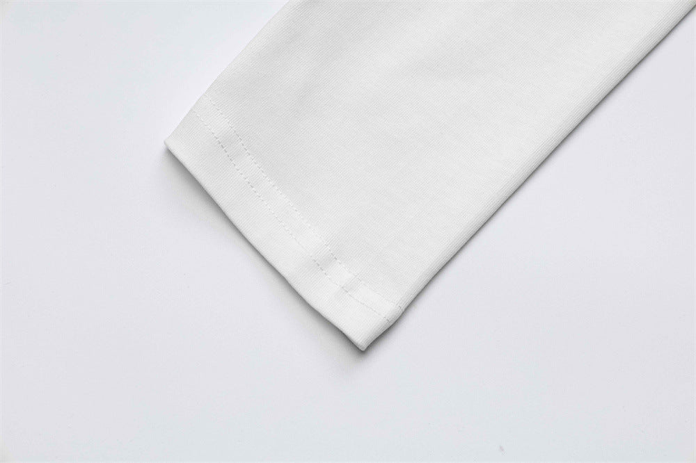 White sleeve cuff close-up with stitched hem