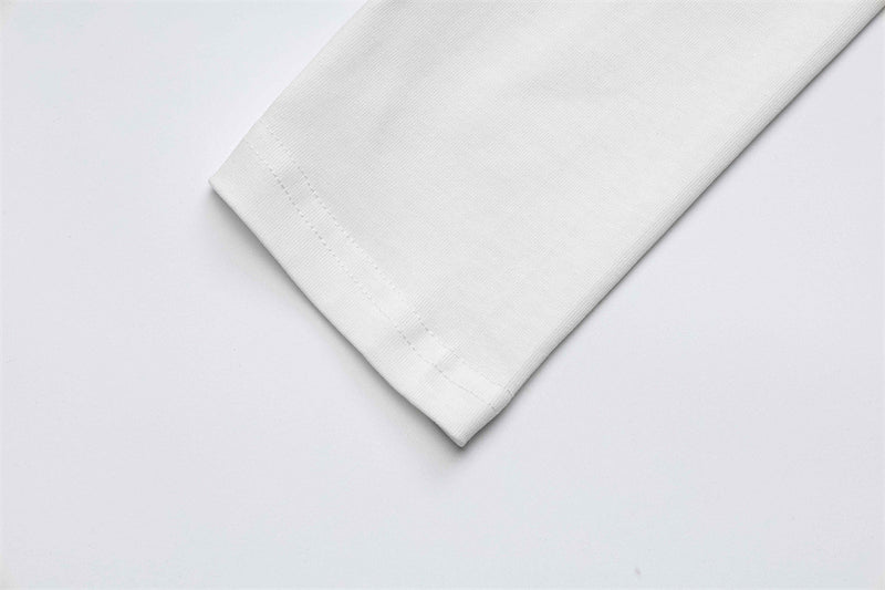 White sleeve cuff close-up with stitched hem