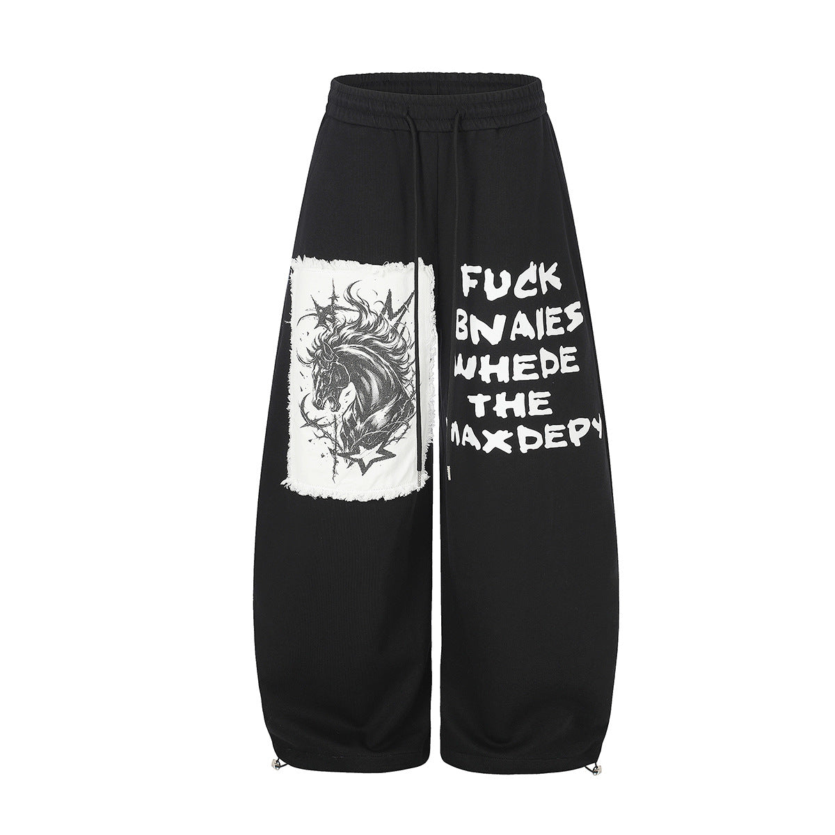 Pantalon de survêtement noir à jambes larges avec écusson licorne effet usé et imprimé texte style graffiti sur la jambe, vue de face