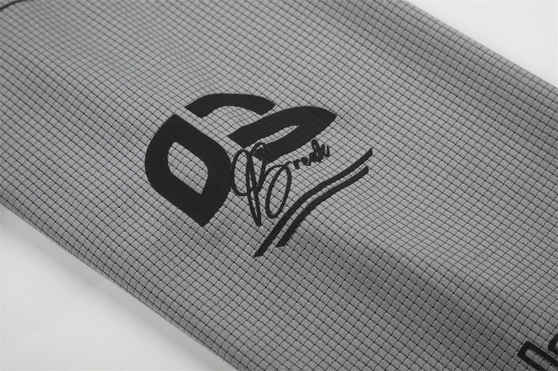 Close-up of gray sleeve graphic with bold 02 logo and script print
