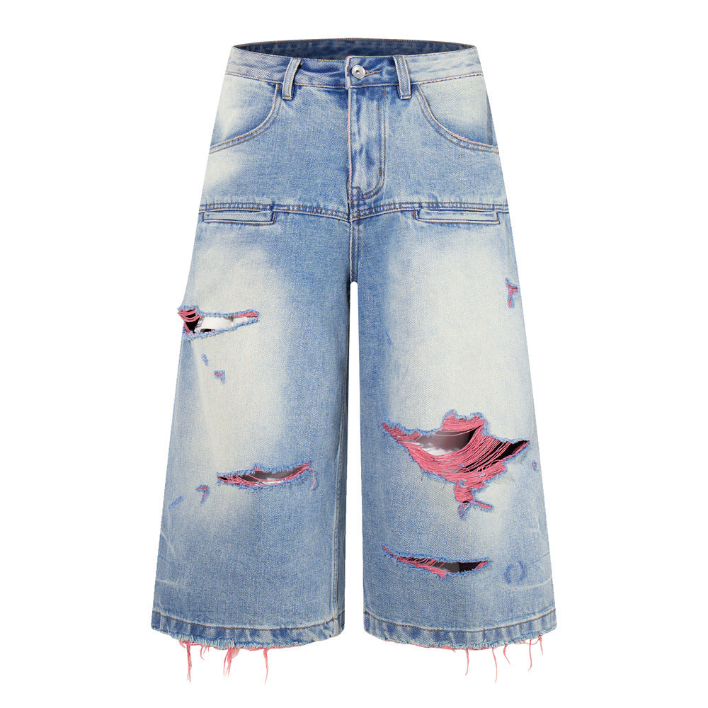 Ripped wide-leg denim shorts in washed light blue with pink thread distressing and raw frayed hem, front and back view