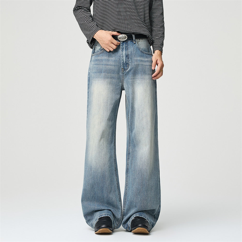 Men's wide-leg baggy jeans in light blue vintage washed denim with whisker fading and gold stitching, front and back view