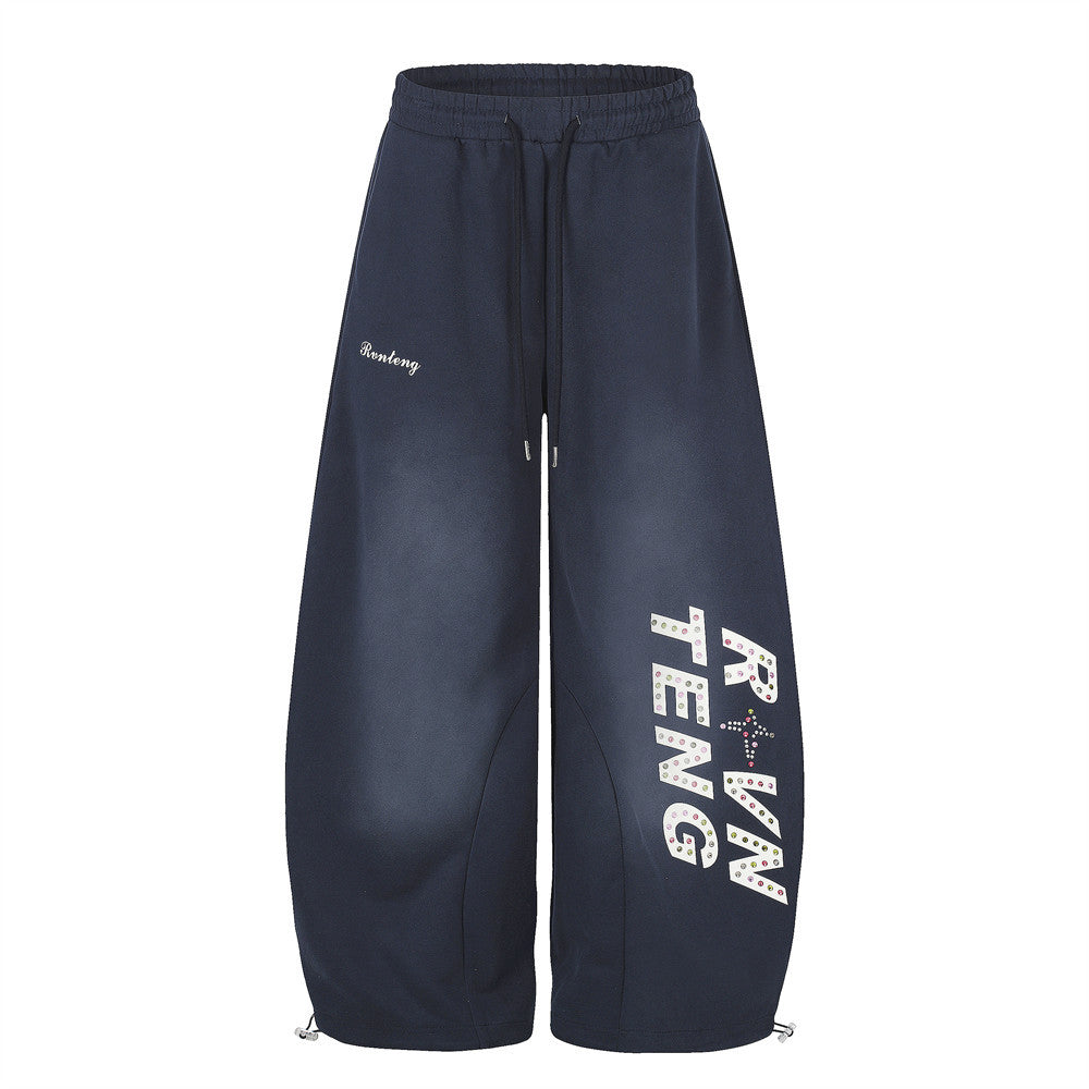 Men's wide-leg sweatpants in navy with rhinestone letter graphic print and curved arc hem