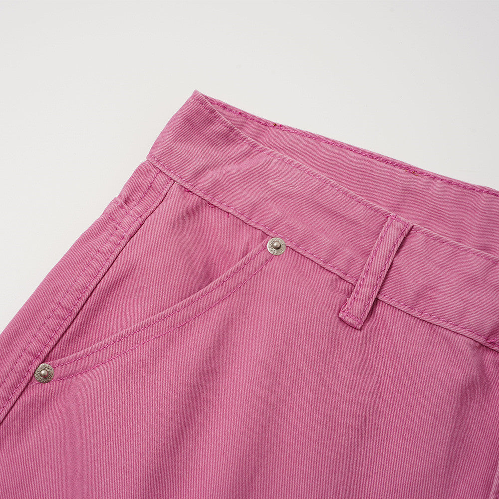 Close-up of rose pink shorts front pocket and waistband stitching