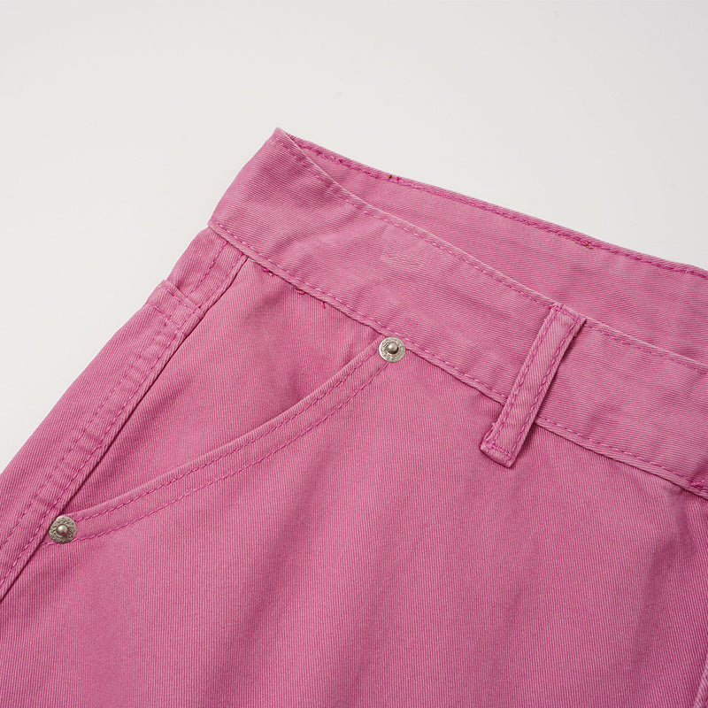 Close-up of rose pink shorts front pocket and waistband stitching