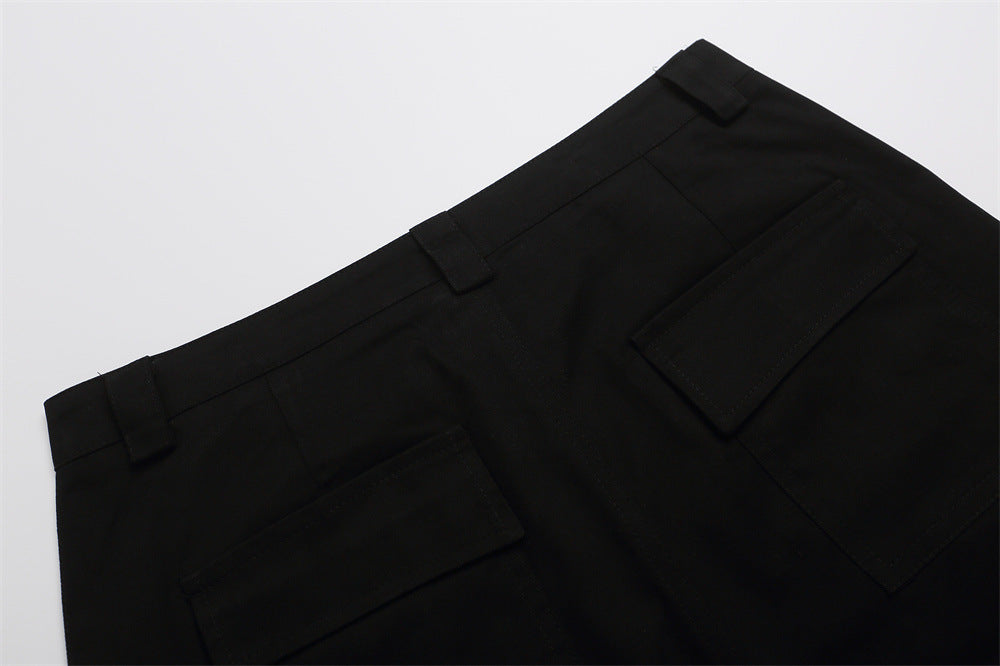 Close-up of black shorts back with flap pockets and belt loops