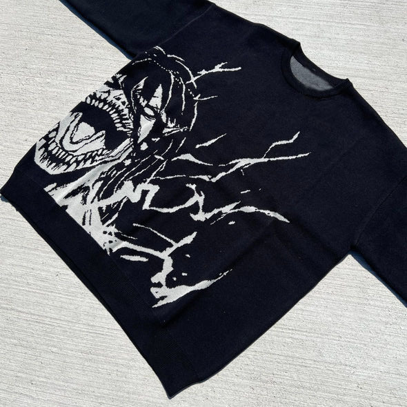 A black streetwear sweater with a jacquard design of Eren Yeager's Titan form and abstract lines is rendered in white for bold contrast. The Premium Attack on Titan-Inspired Knit Sweater, from the Attack on Titan brand, is photographed flat on a textured surface.