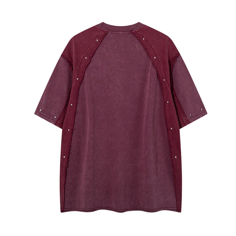 T-shirt patchwork raglan délavé à l’acide, coutures à bords bruts et détails rivetés
