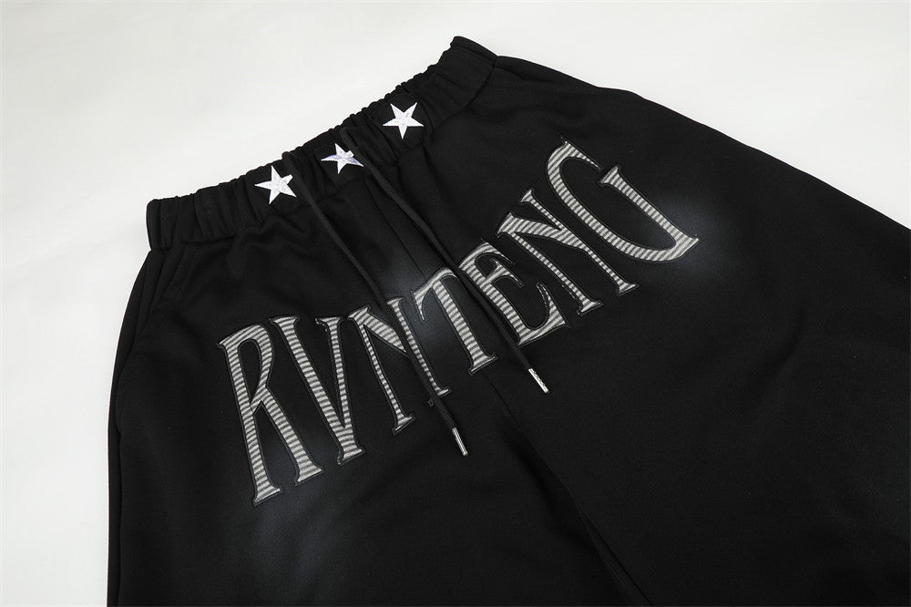 Pantalones de chándal holgados de pernera ancha con lavado efecto spray y gráfico de letras