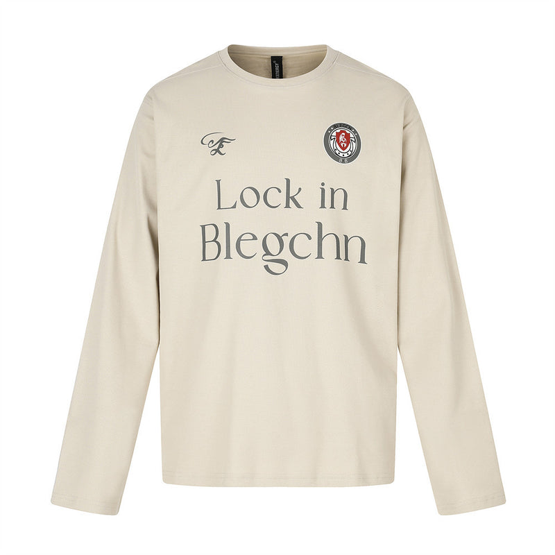 Beige long sleeve crew neck tee, flat lay front view with chest graphic and logo patch