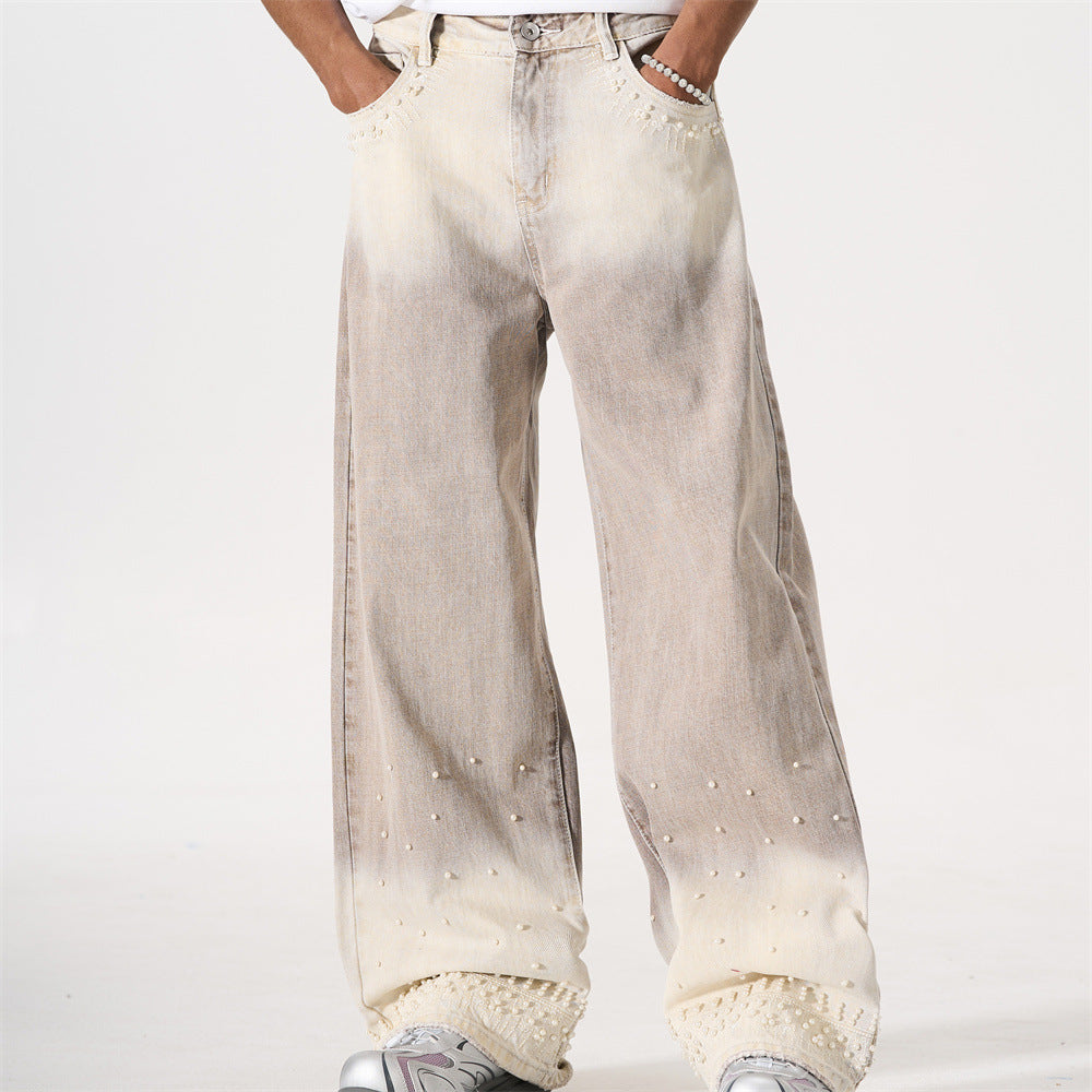 Men's wide-leg gradient tie-dye jeans with pearl bead embellishments on hem and pockets, khaki to cream ombre wash, front and