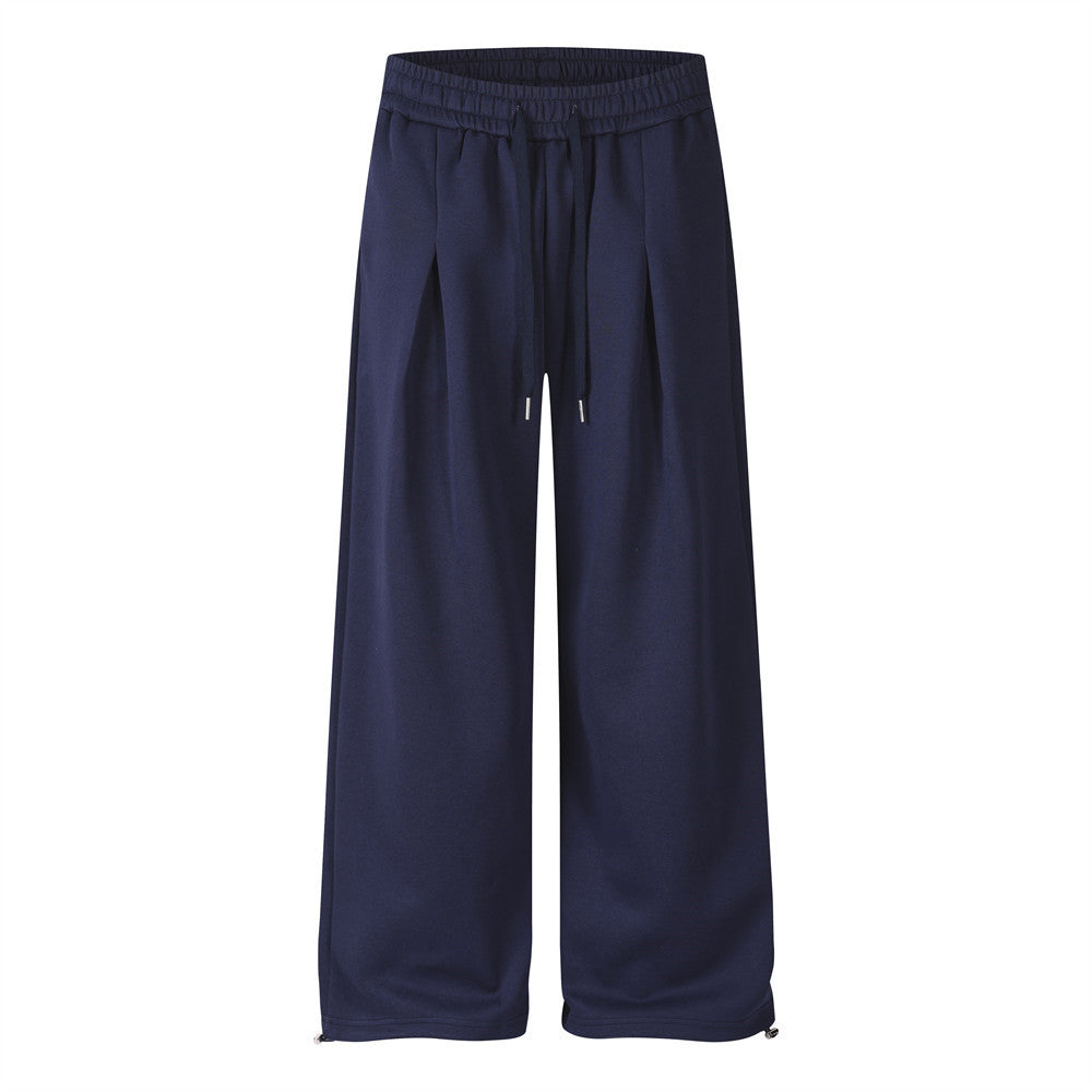 Pantalon de survêtement homme à jambes larges, imprimé étoile rouge et lettres sur fond bleu marine, présenté de face et de dos avec cordon de serrage plissé