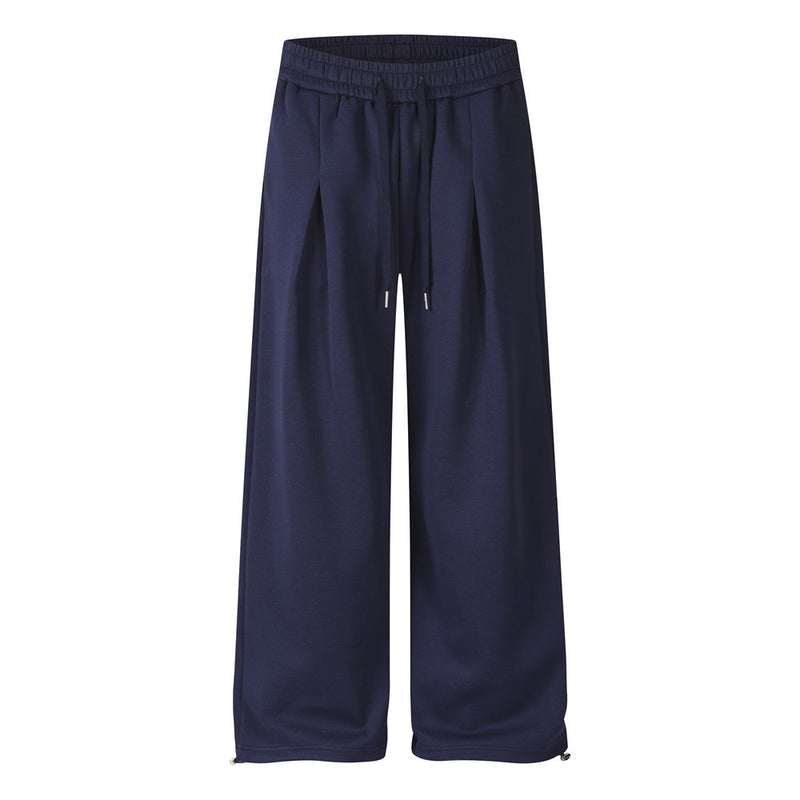 Pantalon de survêtement homme à jambes larges, imprimé étoile rouge et lettres sur fond bleu marine, présenté de face et de dos avec cordon de serrage plissé