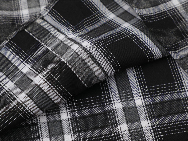 Close-up of black and white plaid flannel fabric with folded layers