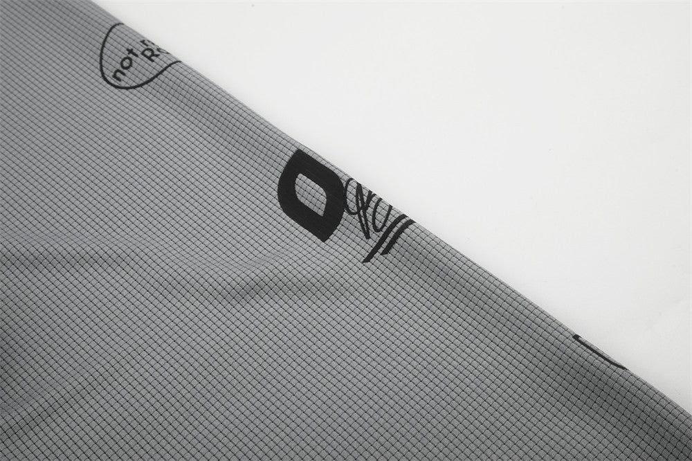 Close-up of gray sleeve showing black logo print and not refined rain text