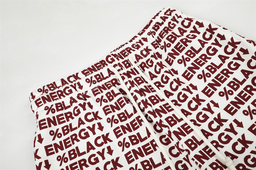 Close-up of white sweatpants waistband seam and red BLACK ENERGY print