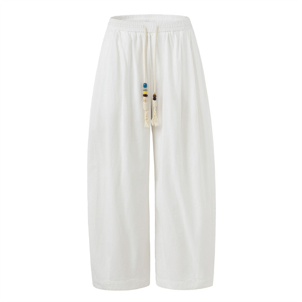 Men's baggy wide-leg pants in white with beaded drawstring and elastic waistband, relaxed street style fit