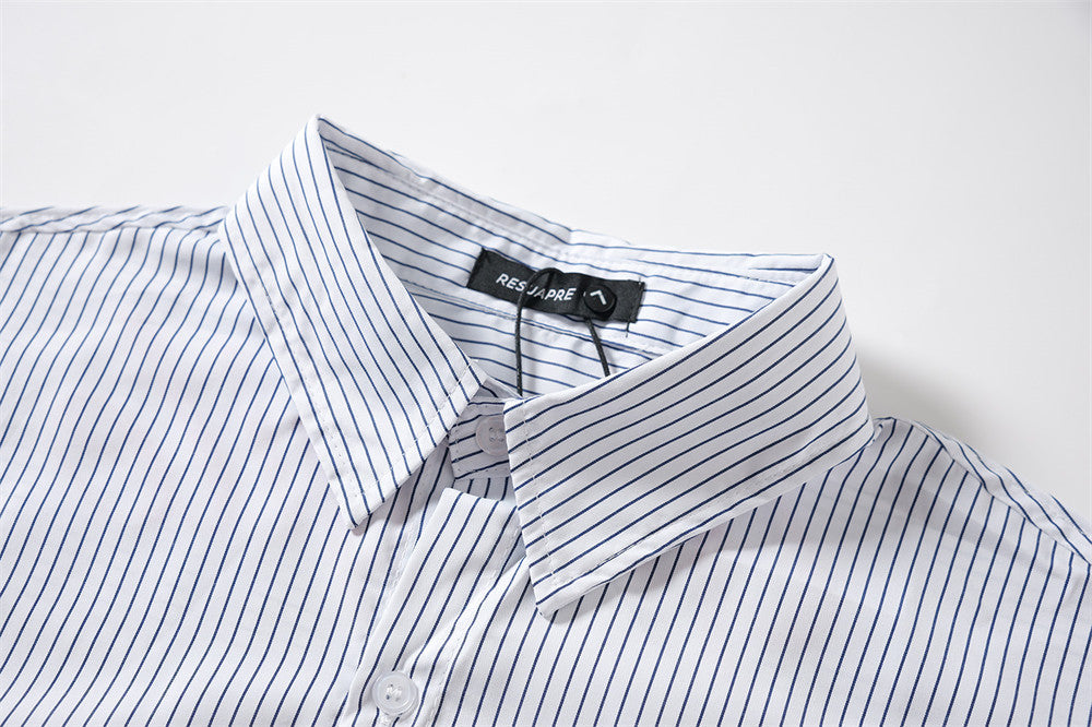 Close-up of striped shirt collar with pointed collar and woven neck label