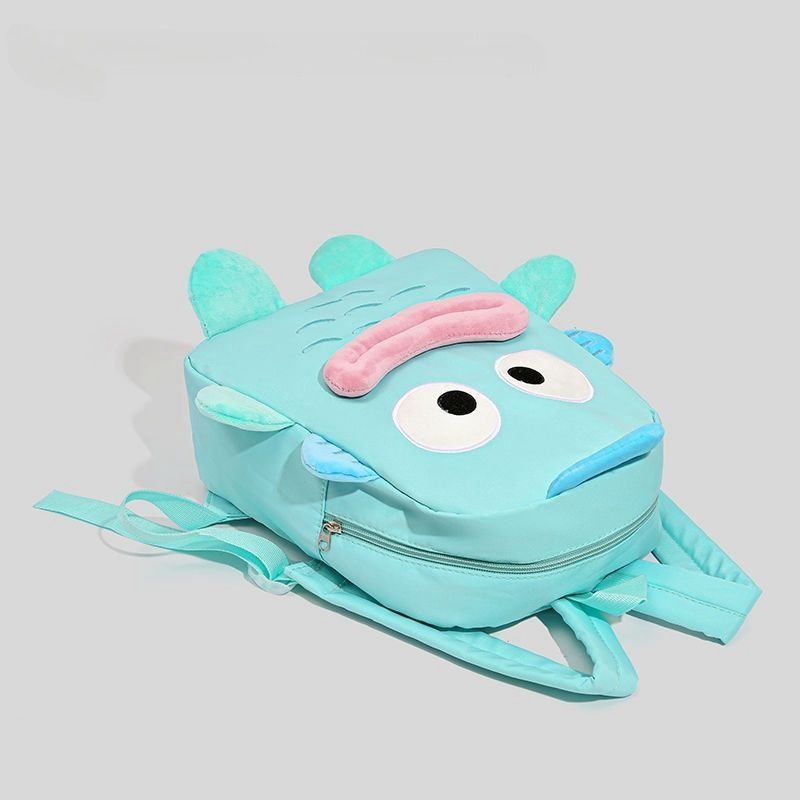 The Seakoff Adorable Clownfish Backpack for Kids features a playful underwater-themed clownfish design with large eyes, a pink smile, and blue fins on light blue. Displayed on a gray background, it includes adjustable straps for comfort.