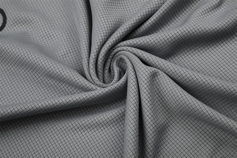 Close-up of gray mesh knit fabric gathered in a swirl
