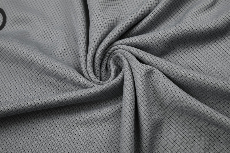 Close-up of gray mesh knit fabric gathered in a swirl