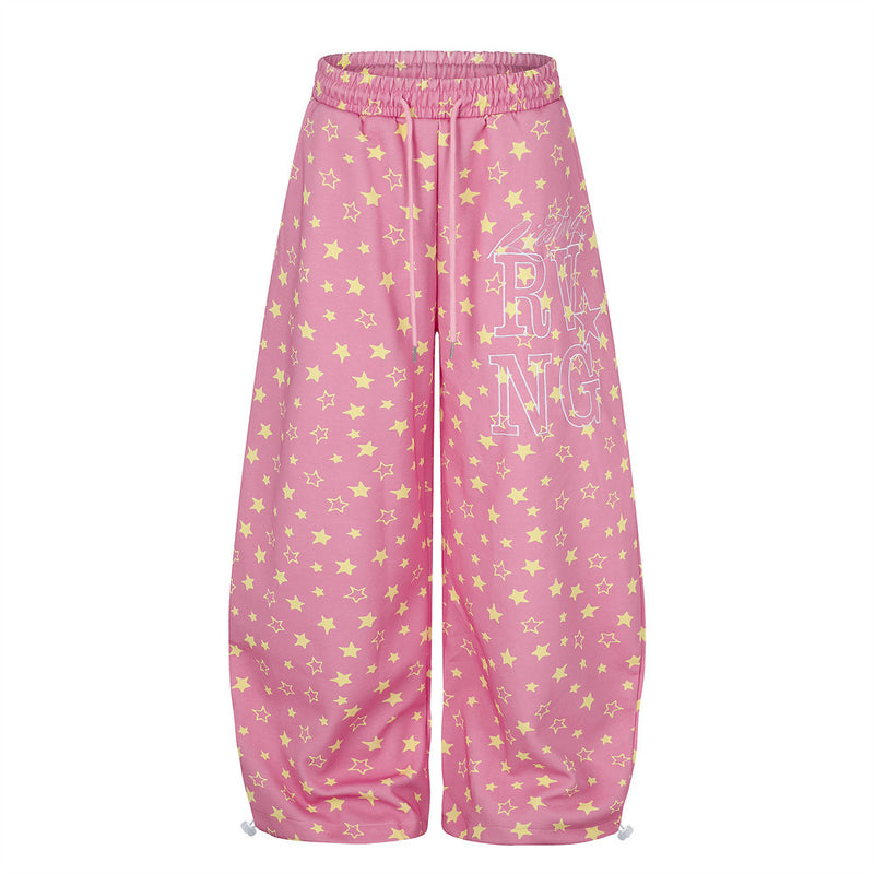 Pink wide leg star print sweatpants, front view with drawstring waistband