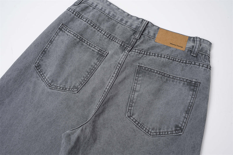 Back view of grey jeans with two patch pockets and tan waistband label