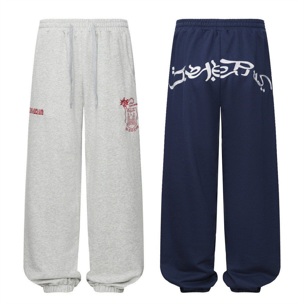 Pantalon de survêtement homme à jambes larges avec écusson brodé et imprimé graphique en écriture