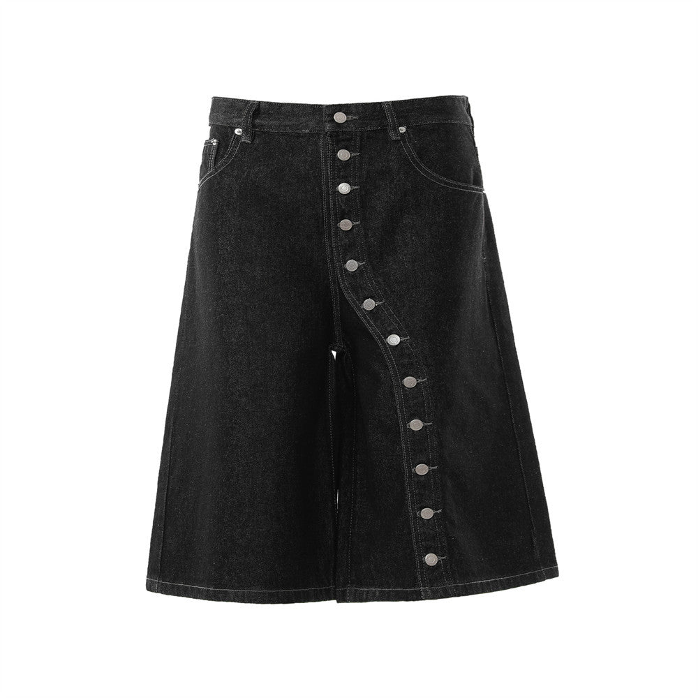 Black washed denim wide-leg shorts with diagonal silver snap-button placket and contrasting white topstitching, front view