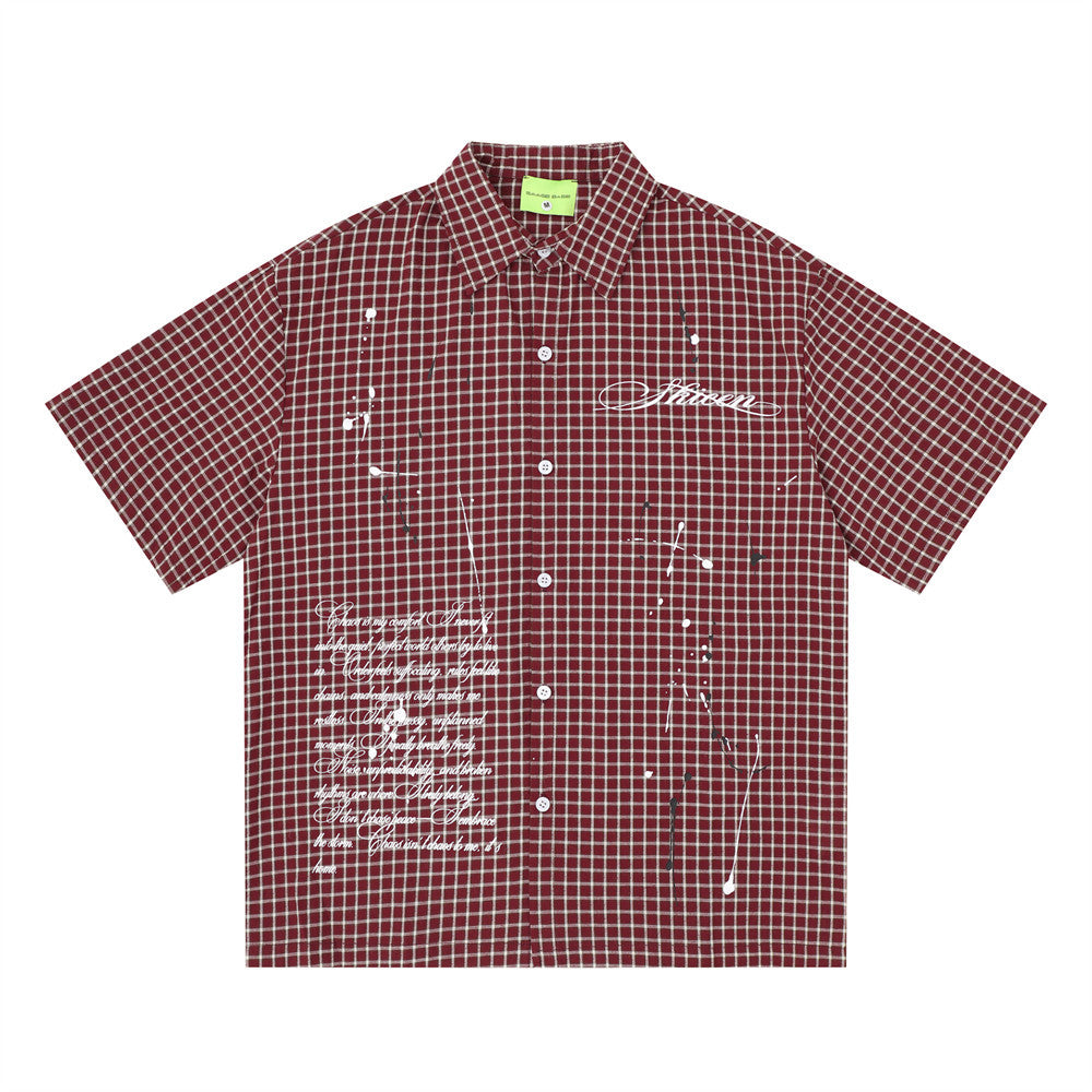 Oversized plaid check short sleeve shirt in burgundy with white script print and paint splatter graphic details, streetwear s