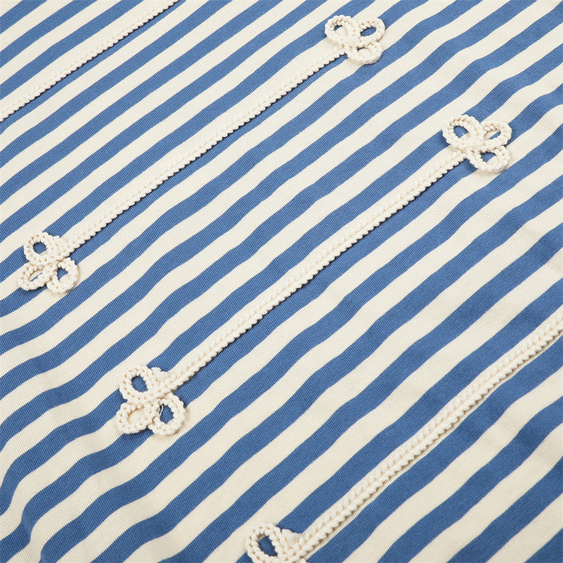 Close-up of blue and cream striped shirt front with repeated floral knit trim details