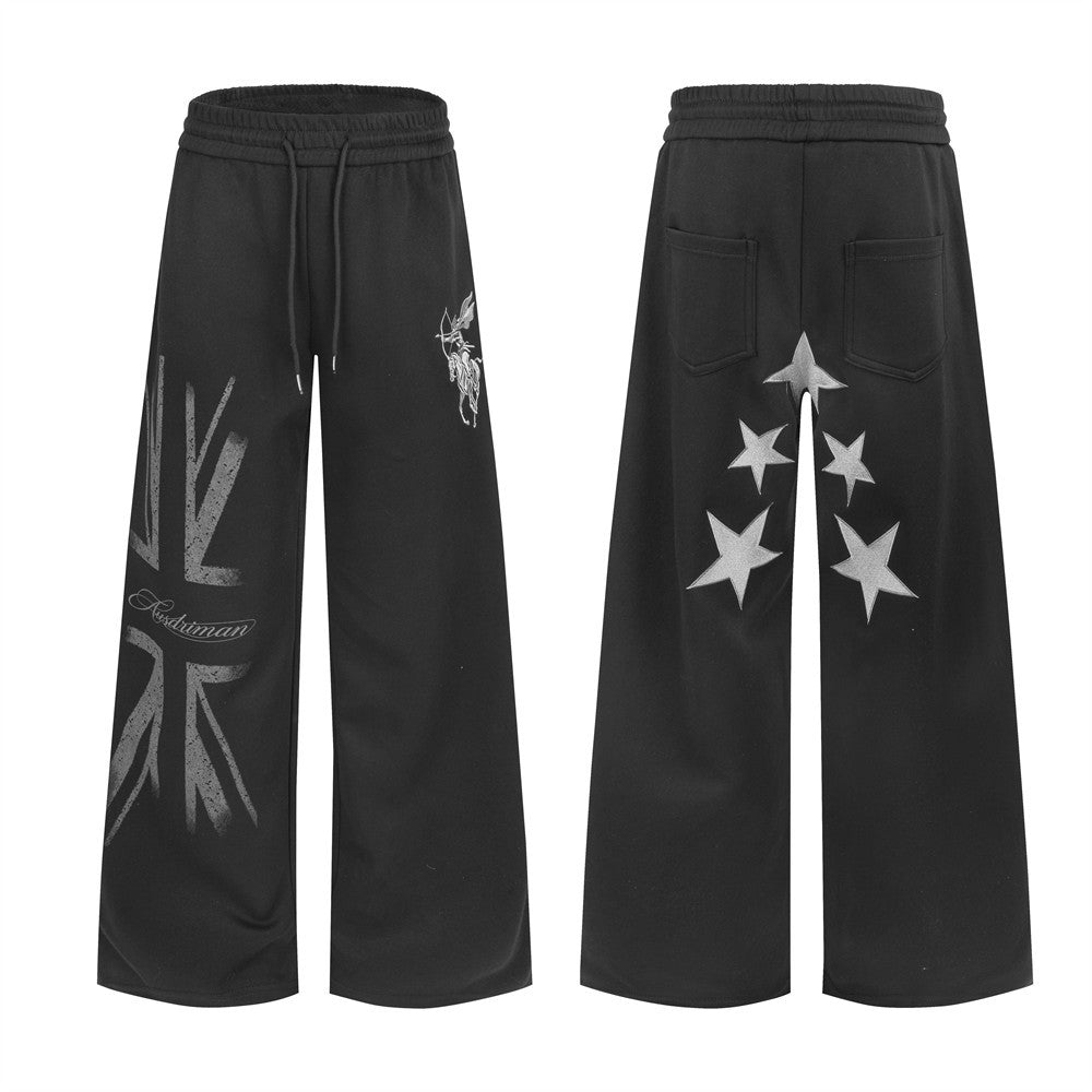 Men's black wide-leg sweatpants with Union Jack graphic on left leg and star appliqués on the back, front and back view