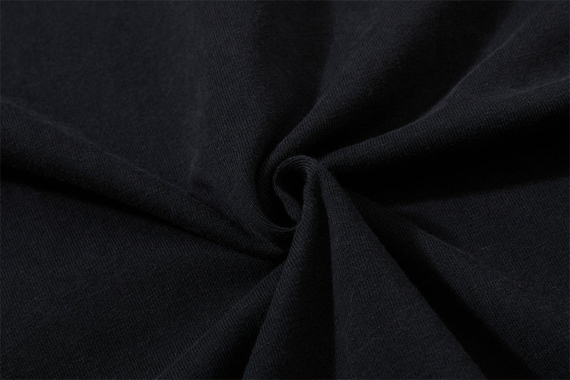 Close-up of black knit fabric gathered into a swirl