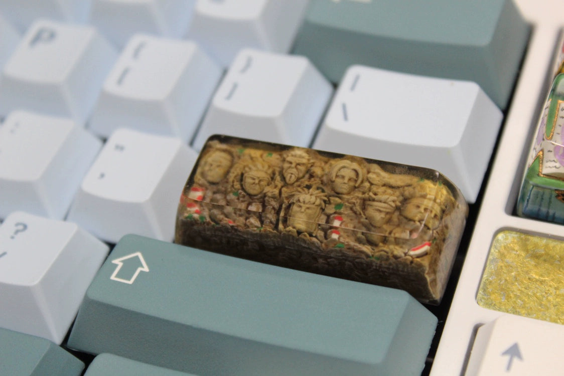 The Hokage Monument Keycap by Naruto is a custom spacebar keycap for Cherry MX switches, dazzling Naruto fans with intricately carved Hokage faces among vibrant details in elegant white and teal.