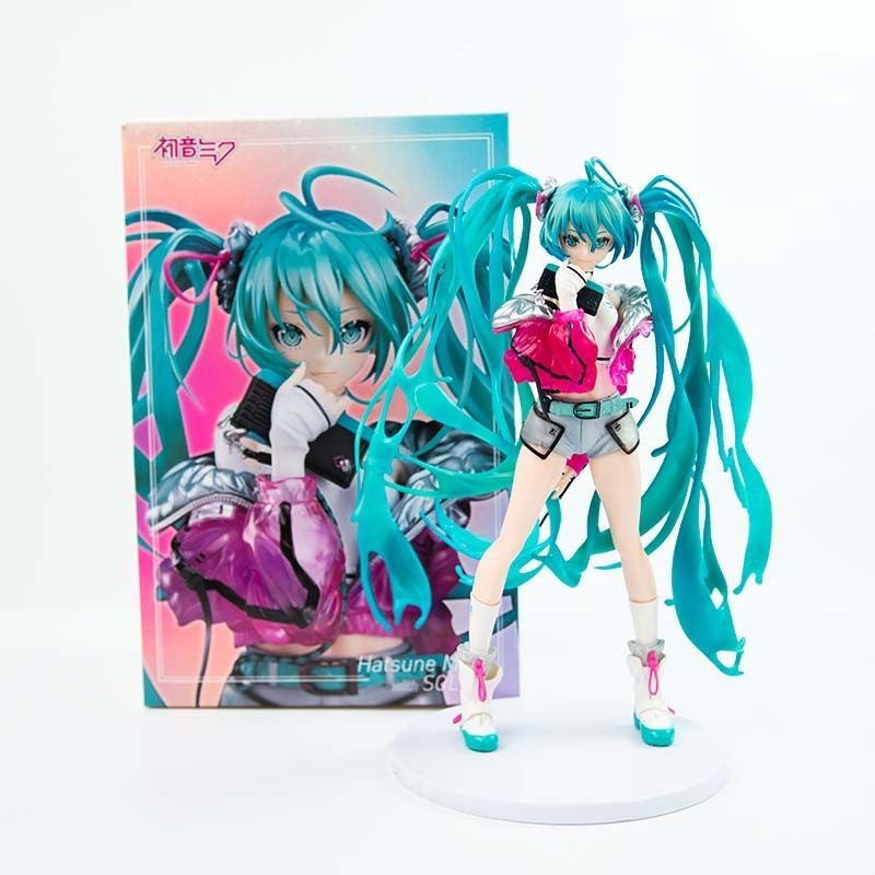 The Hatsune Miku 24cm PVC Figure by Hatsune Miku is a high-quality Vocaloid collectible, showcasing her iconic turquoise twin tails and black, pink, and white detailed outfit. The figure stands on a white base with a vibrant display box featuring an illustration of the beloved character.