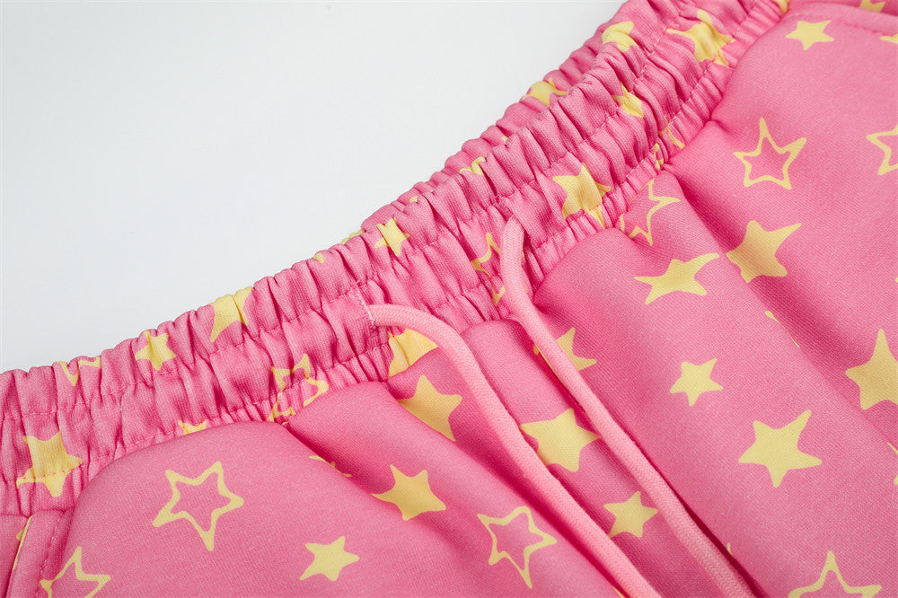 Close-up of pink star print sweatpants elastic waistband and drawstring