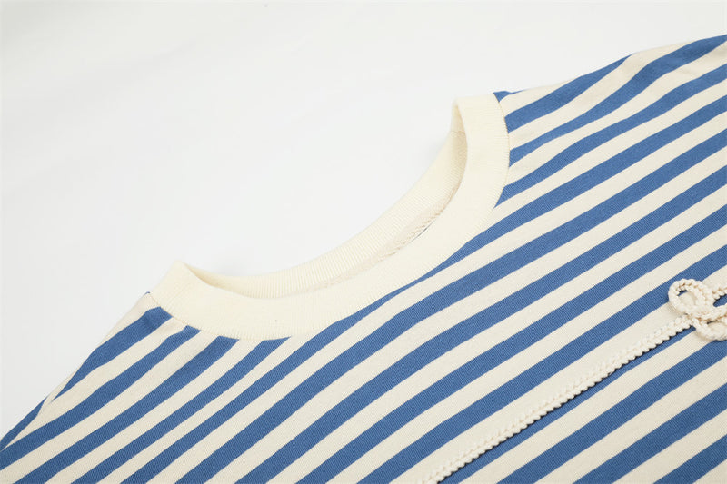 Close-up of blue and cream striped shirt neckline and floral knit front detail