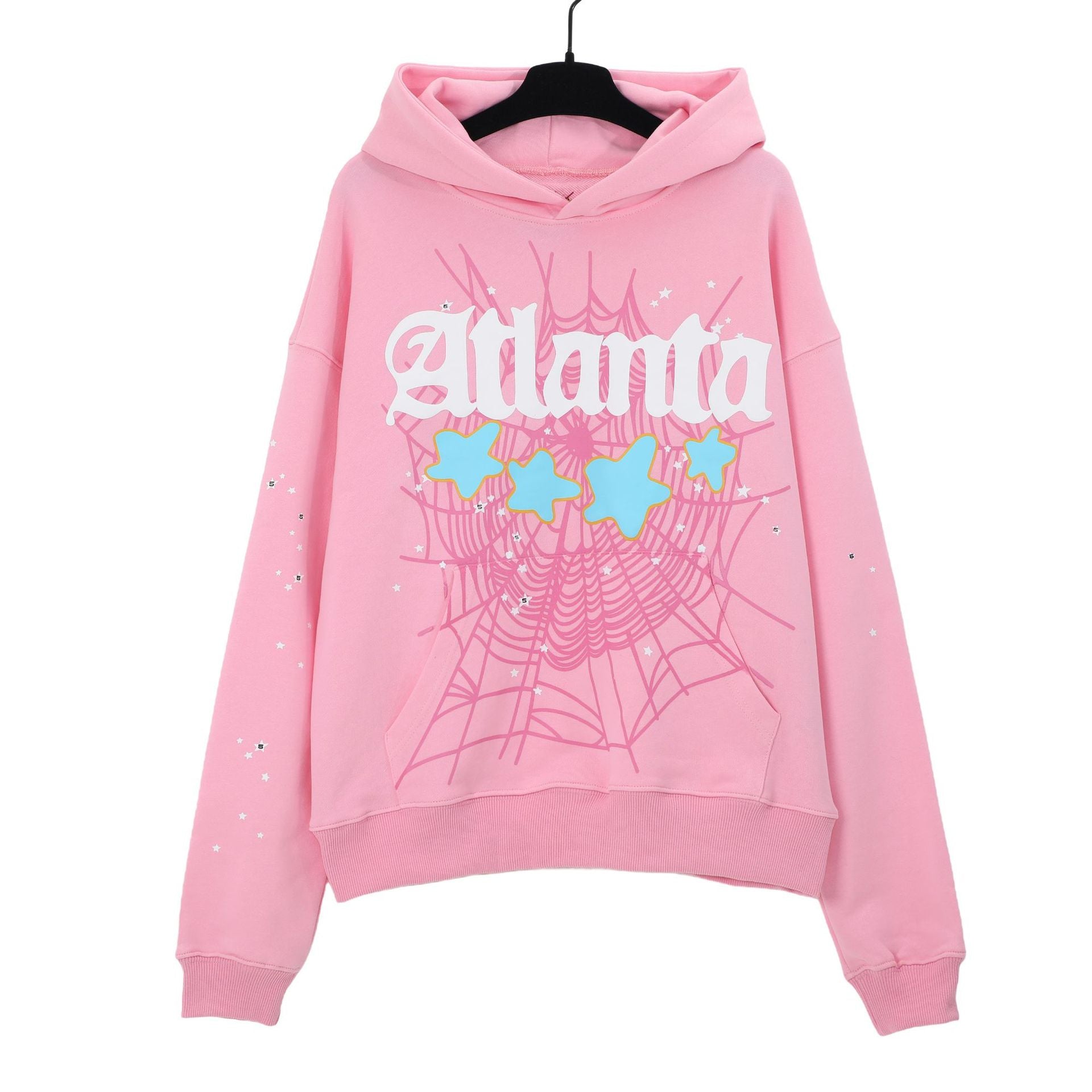 A chic pink hooded sweatshirt by Sp5der featuring &quot;Atlanta&quot; in white and a star within a spider web design. Displayed elegantly on a hanger, it includes a drawstring hood.