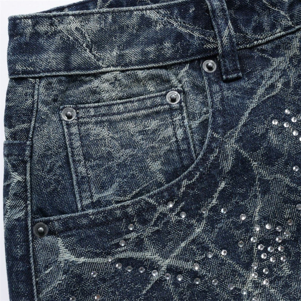 Close-up of front pocket and waistband on distressed jeans with rhinestone details