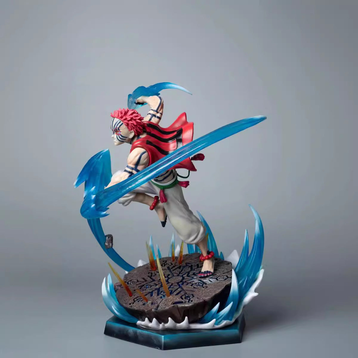 The Rengoku Kyojuro Demon Slayer Figure, a 26cm PVC collectible with light-up effects, features a red spiky hairstyle and wields a blue crescent-shaped weapon. Its dynamic ice powers and runic base make it a standout piece for any anime fan.